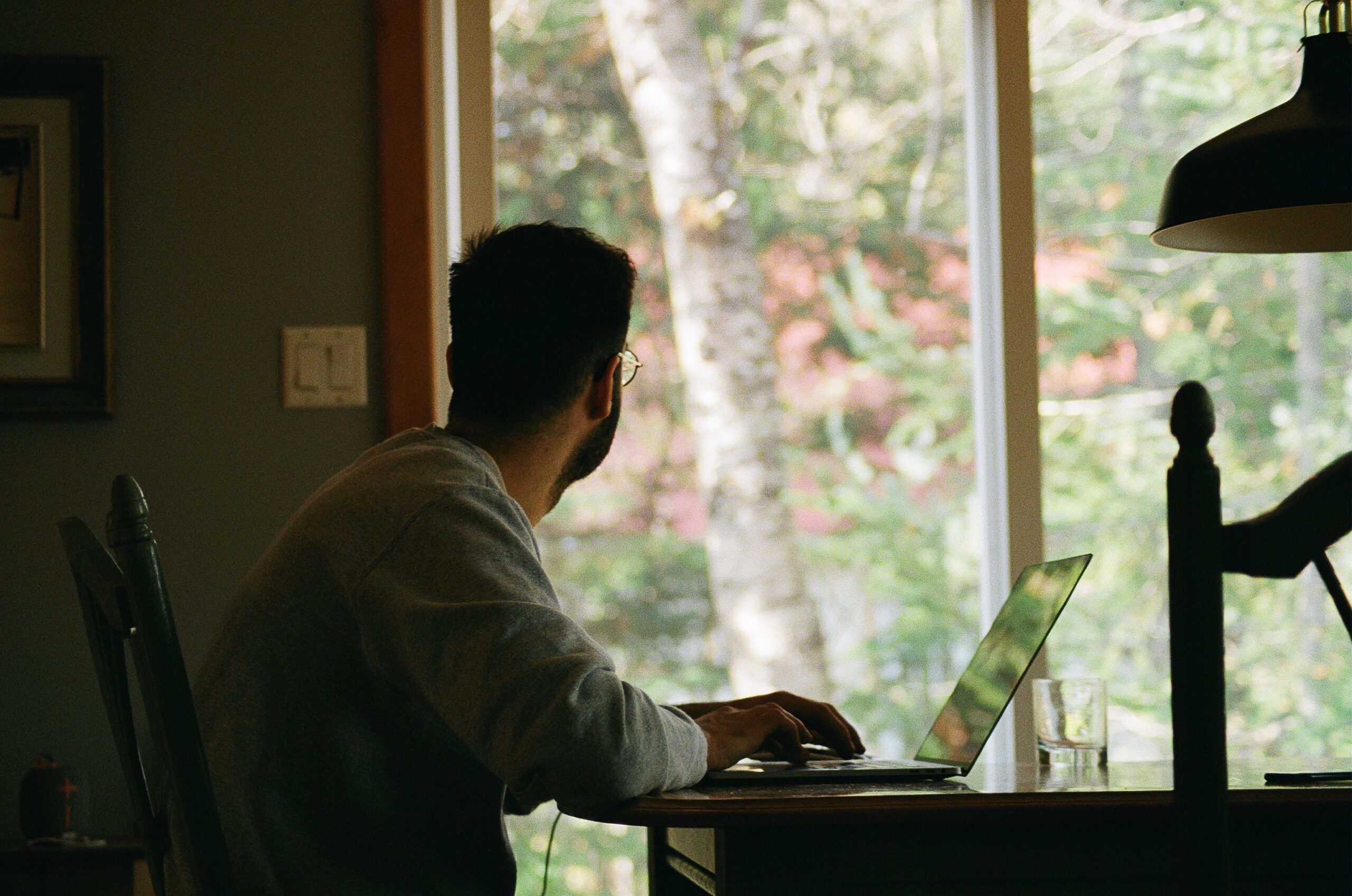 Picture of man sitting at desk looking outside